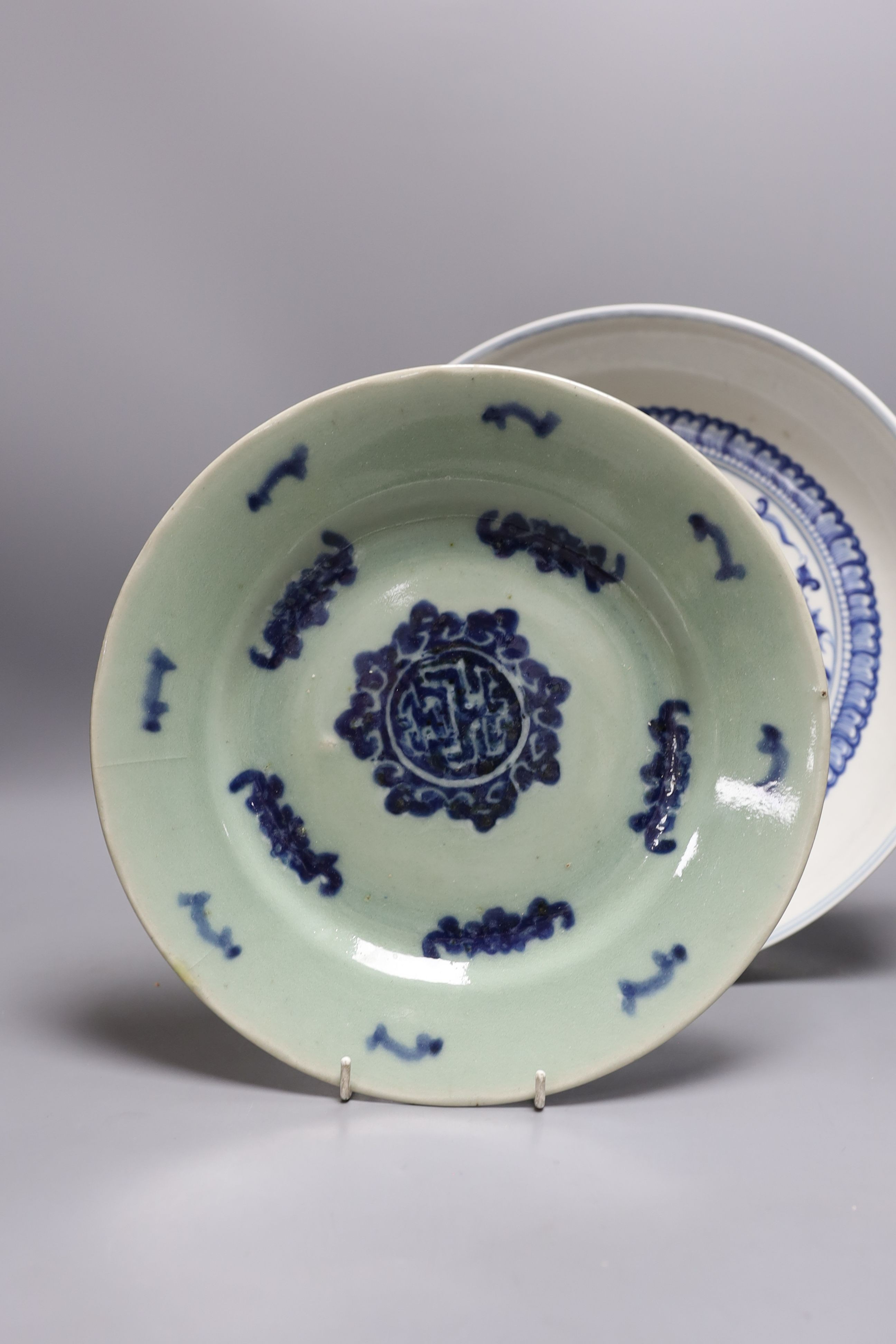 A 19th century Chinese blue and white celadon ground charger, marked to base, together with another blue and white Chinese charger (2)